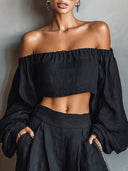 Conjunto de top negro con hombros al descubierto de manga larga y pantalones de pierna ancha